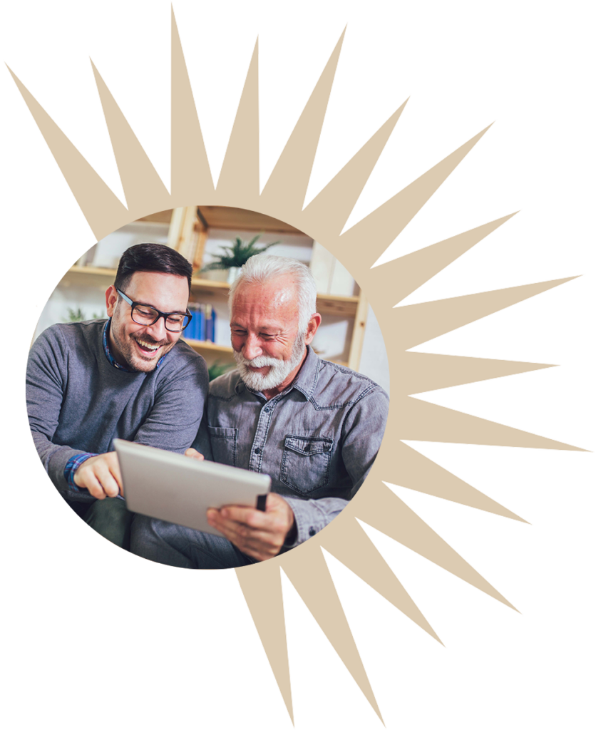 a senior uses a tablet with help from a young adult