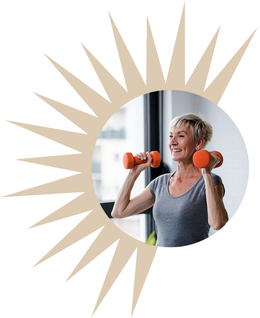 a senior smiles while lifting weights