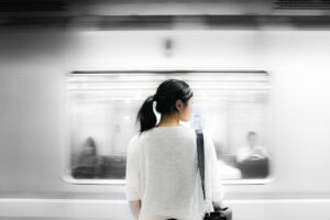 person standing near a moving train
