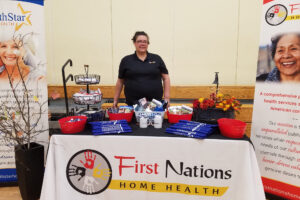 an employee at a "First Nations Home Health" conference booth