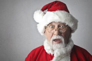 a senior dressed as santa looks surprised