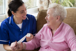 a nurse cares for a smiling senior