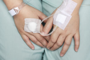 two hands receiving infusion therapy