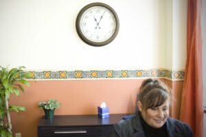 TRU Healthcare employee in front of a clock