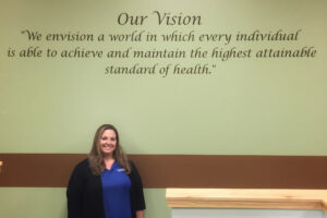 TRU Healthcare employee beneath test "Our vision We envision a world in which every individual is able to achieve and maintain the highest attainable standard of health"