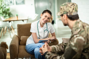 Nurse smiles while talking to vet about veterans recovering from an illness