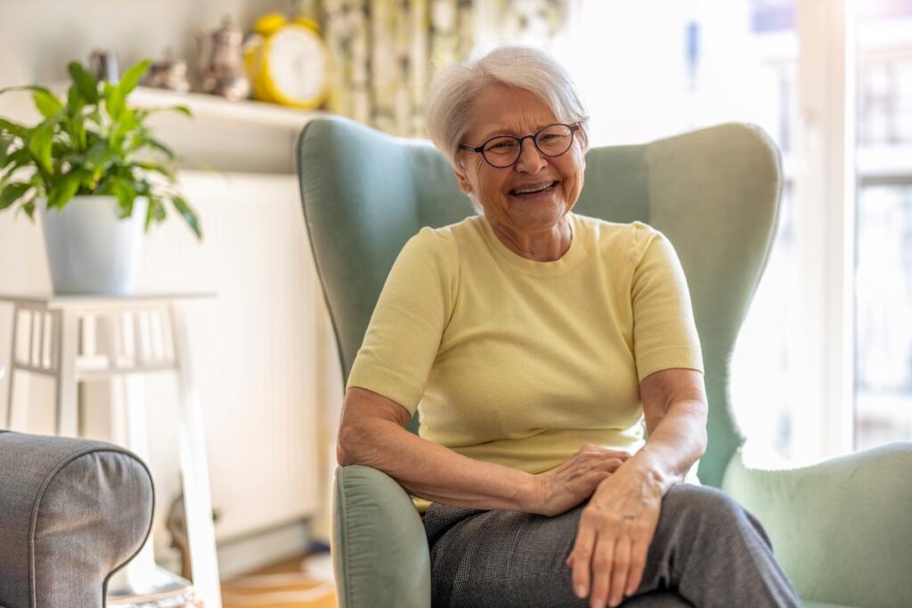 Senior sits on chair and smiles and wonders what are maintenance therapy examples