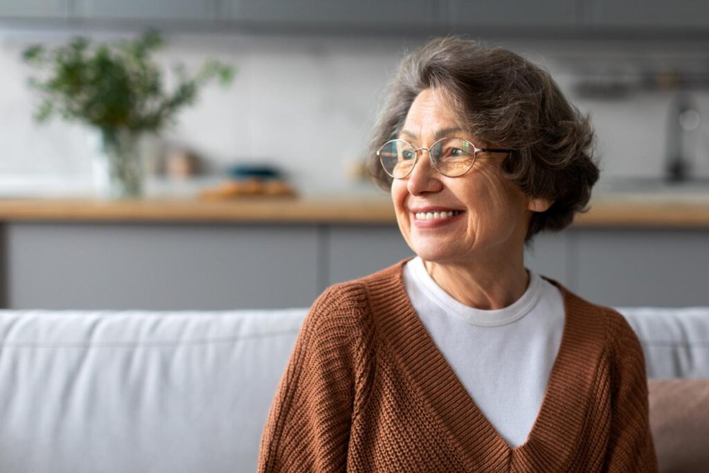 Woman sits on couch and wonders what is at home healthcare