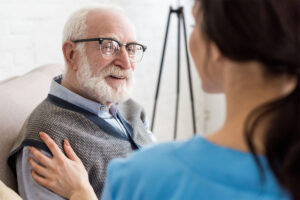 Woman talks to senior about home health services for veterans in Bemidji