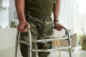 man in skilled home health care for veterans moves across room