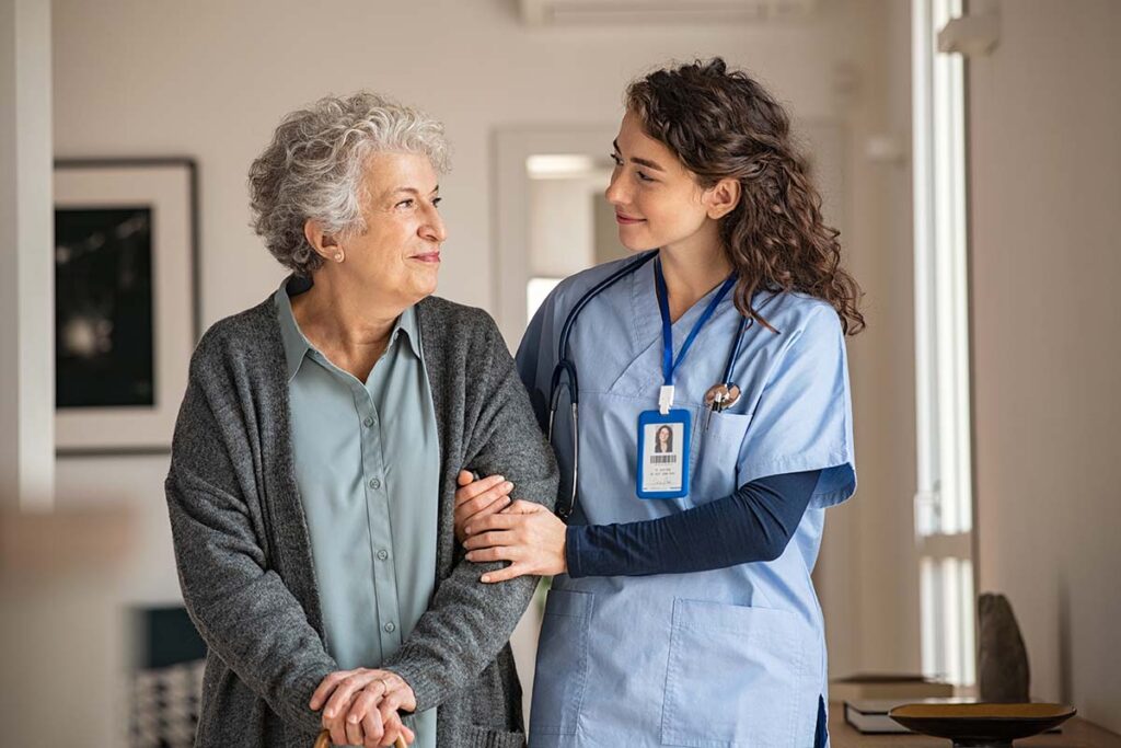 Woman talks to senior about mobility assistance