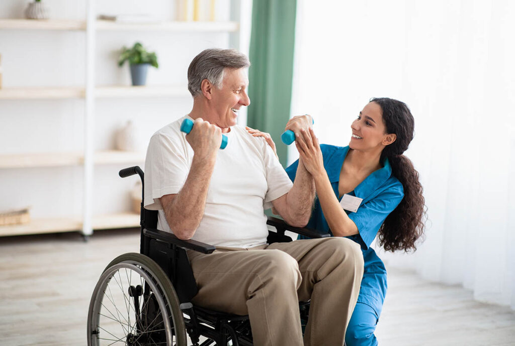 Man lifts weights while discussing benefits of physical therapy for seniors​ with his nurse