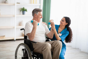Man lifts weights while discussing benefits of physical therapy for seniors​ with his nurse