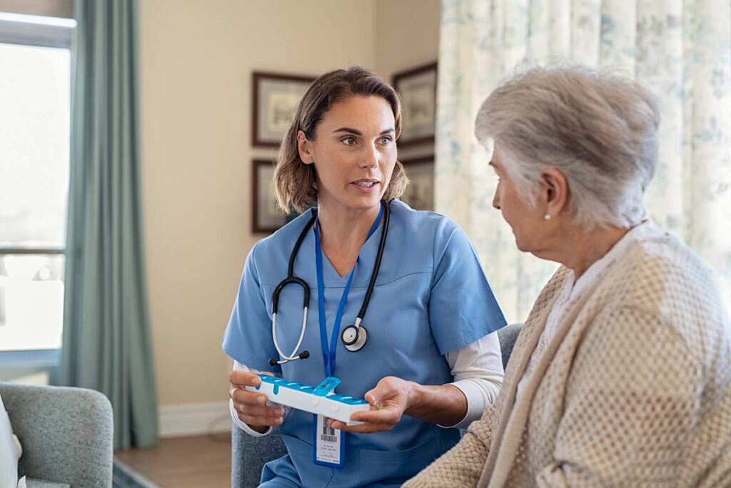Senior talks to therapist about medication management in home health care