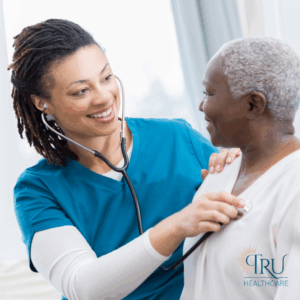 A nurse helping a patient with post surgery care at home.