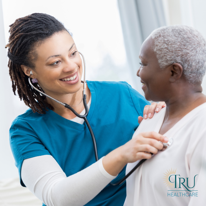 A nurse helping a patient with post surgery care at home.